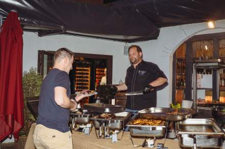 Équipe de La Cabane Meudon devant un buffet barbecue en soirée, restaurant convivial en forêt à Meudon