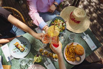 Boissons et plats partagés sur la table de La Cabane Meudon, restaurant convivial avec terrasse en pleine nature à Meudon